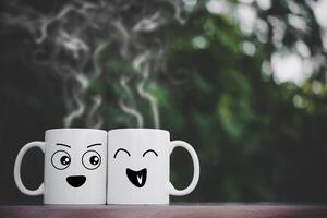 Two happy cups on wood table  with bokeh photo