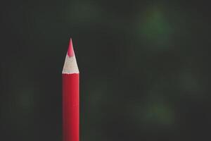 Red pencil representing the concept of Standing out from the crowd photo