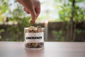 Hand  putting coins in jar with money stack step growing growth saving money photo