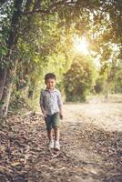 Happy boy playing alone in the park photo