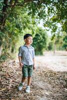 Happy boy playing alone in the park photo