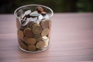 save money for investment concept coin in the glass jar photo