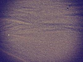 textura de arena oscura en el mar foto
