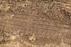 car wheel tracks on the ground photo