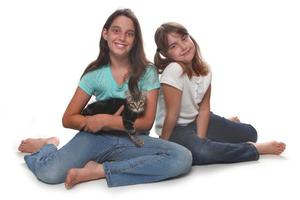 Two Sisters Holding Their Young Kitten photo