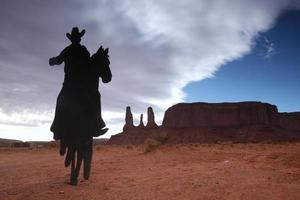 Three Sisters Monument With Cowboy Silhouette photo