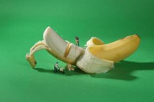 Construction Workers in Conceptual Food Imagery With Banana photo