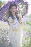 Pretty Young Girl Outdoors in a Lavender Flower Field photo