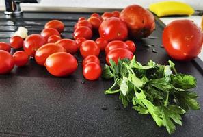 cherry tomatoes, garlic and parsley in Italian cuisine ready to be tasted and eaten photo