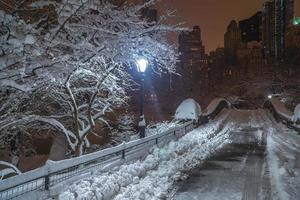 Gapstow Bridge in Central Park at night after snow storm photo