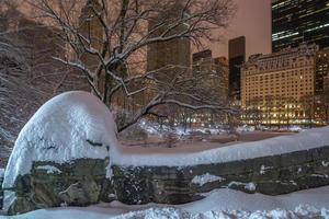 Gapstow Bridge in Central Park at night after snow storm photo
