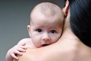 Mother holding sweet baby boy photo