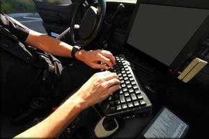 Officer Using in Vehicle Computer for Public Safety photo