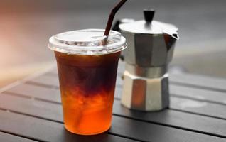 Ice americano coffee in plastic glass from Asian style street cafe. photo