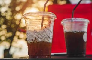 Ice americano coffee in plastic glass from Asian style street cafe. photo