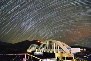 Stars trail at white bridge photo