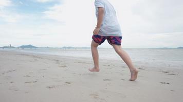 Asian cute boy running happily on the beach with cheerfulness
