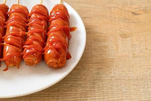 fried sausage skewer with ketchup photo