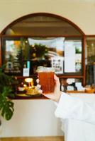 hand holding iced americano coffee glass photo