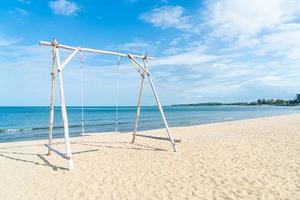 wooden swing on the beach photo