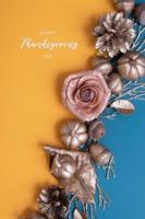 Happy Thanksgiving lettering with flat lay golden pumpkins and acorns on a turquoise background. Creative greeting photo