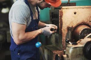 Portrait of a young master working at a factory. photo