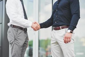 Handshake of two men. Successful business contacts after a good deal photo