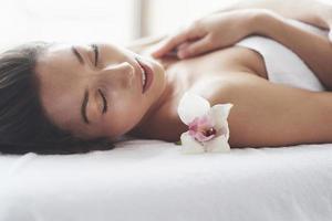 beautiful girl with an orchid perfect skin near the big window. photo