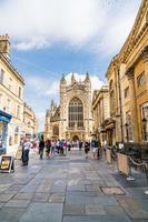 BATH, ENGLAND - AUG 30, 2019 - Bath Abbey with tourist. It is an Anglican parish church and a former Benedictine monastery, founded in the 7th century photo