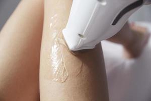 Beautician Giving Epilation Laser Treatment To Woman photo