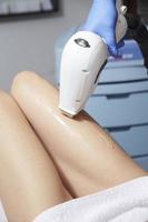 Esteticista dando tratamiento con láser de depilación a la mujer