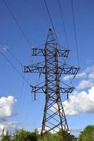 Electric pole against the sky. The high voltage power line runs in the countryside. photo