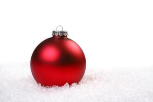 Single Red Shiny Christmas Ornament in the Snow photo