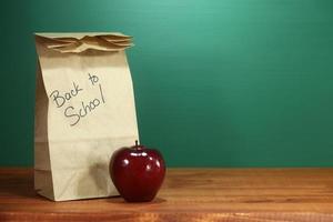 School Lunch Sack Sitting on Teacher Desk photo