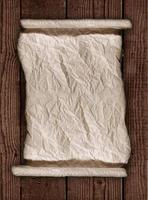 Worn Parchment Paper On a Wooden Rustic Background photo