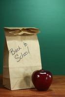 School Lunch Sack Sitting on Teacher Desk photo