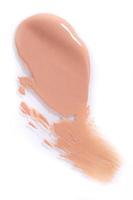 Smeared Liquid Beige Make Up Foundation on White Background photo