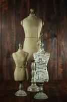 Antique Mannequin Busts on Wood Grunge Background photo