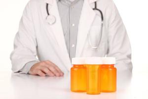 Doctor With Empty Orange Prescription Bottles photo