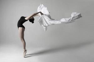 Talented Ballet Dancer in Studio on White Background photo