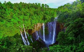 TUMPAK SEWU.Panoramic beautiful deep forest waterfall in Indonesia photo