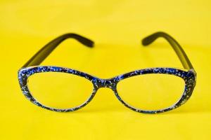 Closeup photo of cool glasses on a yellow background