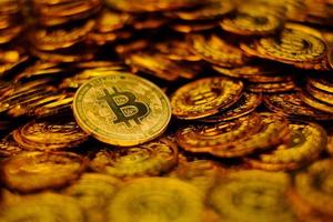 Bitcoin cryptocurrency on pile gold coins a lot of photo