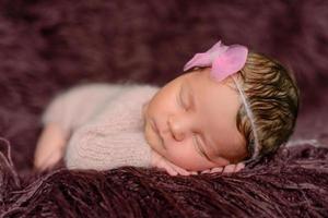 A little newborn girl eight days old. Close-up beautiful sleeping baby girl photo