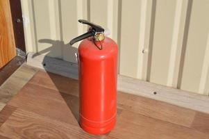Handheld fire extinguisher to protect home and interior from fire photo
