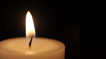 Shot of a candle burning, isolated on black background video