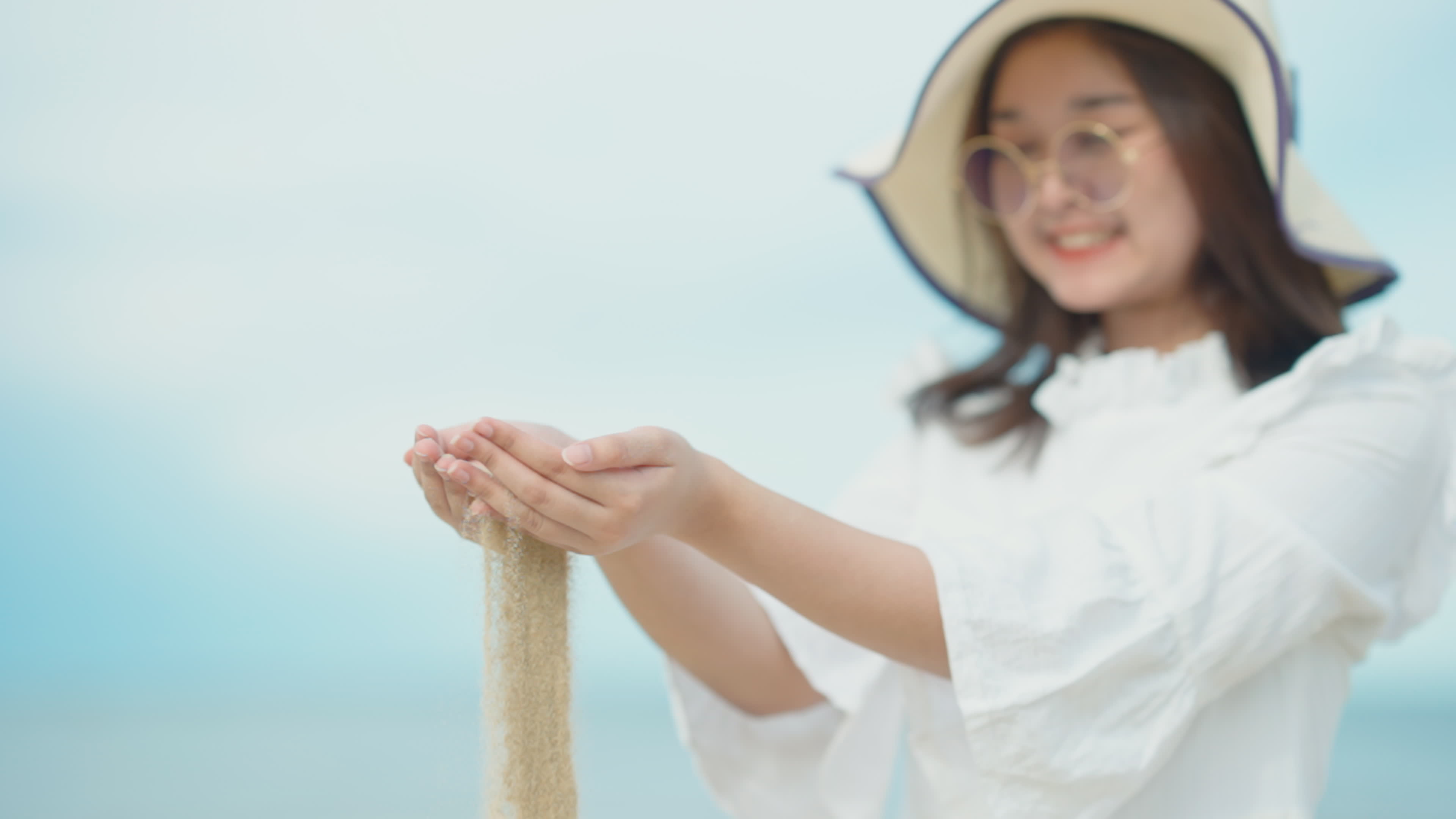 Cute Asian girl walking on the beach by the beach