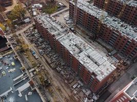 Aerial view of a construction site with buildings under construction and equipment photo