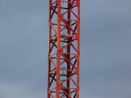 Main girder of a tower crane against cloudy sky background