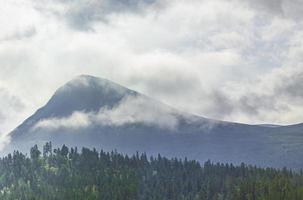 Incredible norwegian landscape with mountains clouds forests Jotunheimen Norway photo